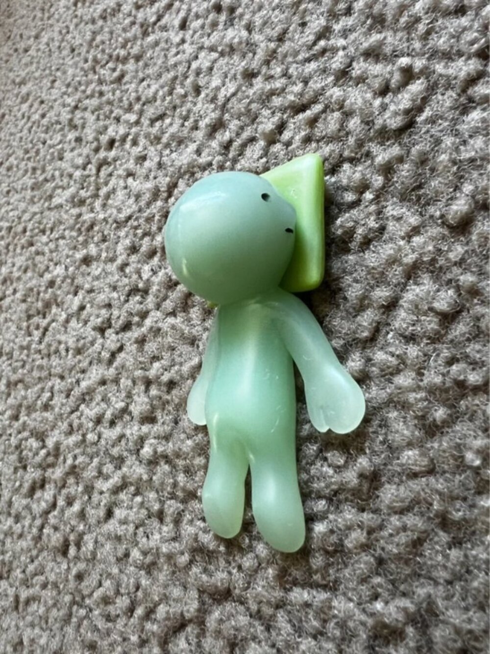 Smiski laying on pillow